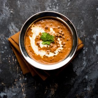Dal makhani or makhni is a popular dish from India. Made with ingredients like whole black lentil, butter and cream. Served with Naan or roti and rice