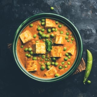 matar paneer curry recipe made using cottage cheese with green peas, served in a bowl. selective focus